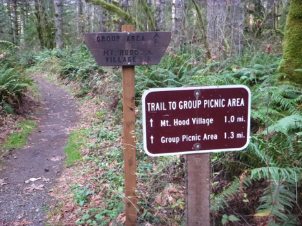 Sign “Trail to group picnic area” – Mt. Hood Village 1 mile – group picnic area 1.3 miles